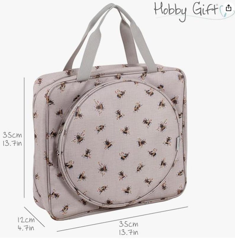 May include: A beige Hobby Gift sewing bag featuring a bee design. The bag is rectangular with a circular front compartment. Dimensions are 35cm wide, 35cm high, and 12cm deep. It has grey handles and the text "Hobby Gift".