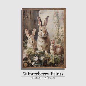 May include: A painting of three brown rabbits in a field of green plants and white flowers. The rabbits are looking at the viewer. The largest rabbit is in the center of the image, and the two smaller rabbits are on either side of it.