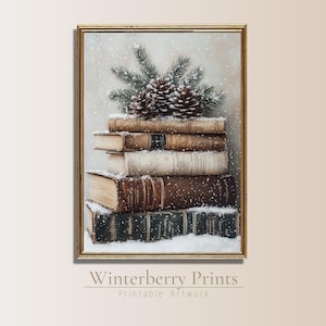 May include: A stack of vintage books with a pine bough and pine cones on top, all covered in a light dusting of snow. The books are arranged in a pyramid shape and have a rustic, antique look.