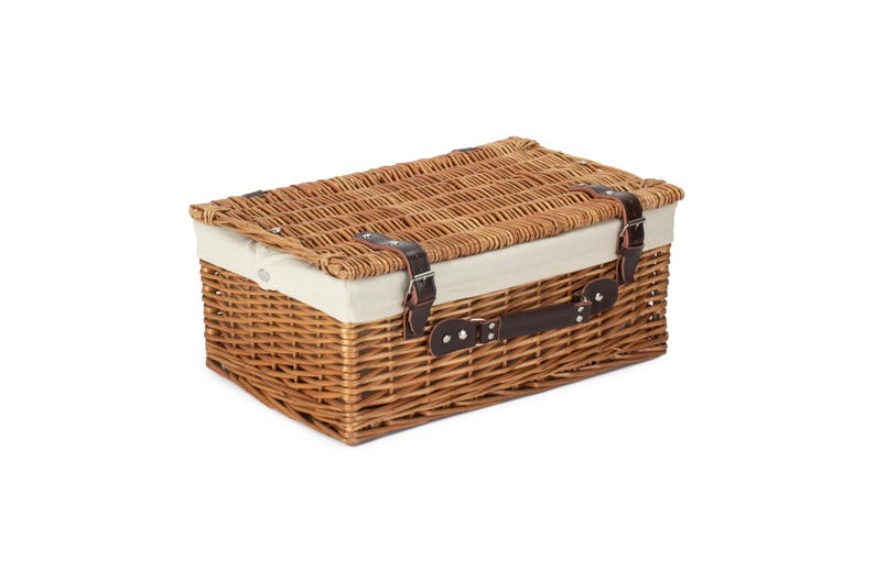 May include: A brown wicker basket with a white fabric lining and a brown leather handle. The basket has two brown leather straps with metal buckles.