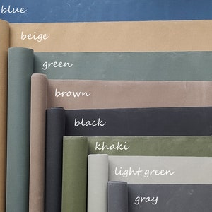 May include: A collection of fabric rolls in various colors, including blue, beige, green, brown, black, khaki, light green, and gray. The fabric rolls are arranged in a vertical stack, with the blue roll at the top and the gray roll at the bottom.