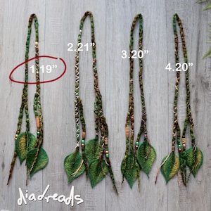 Four hair extensions featuring braided green and brown fibres, accented with small wooden and metallic beads, and finished with felted leaf shapes.