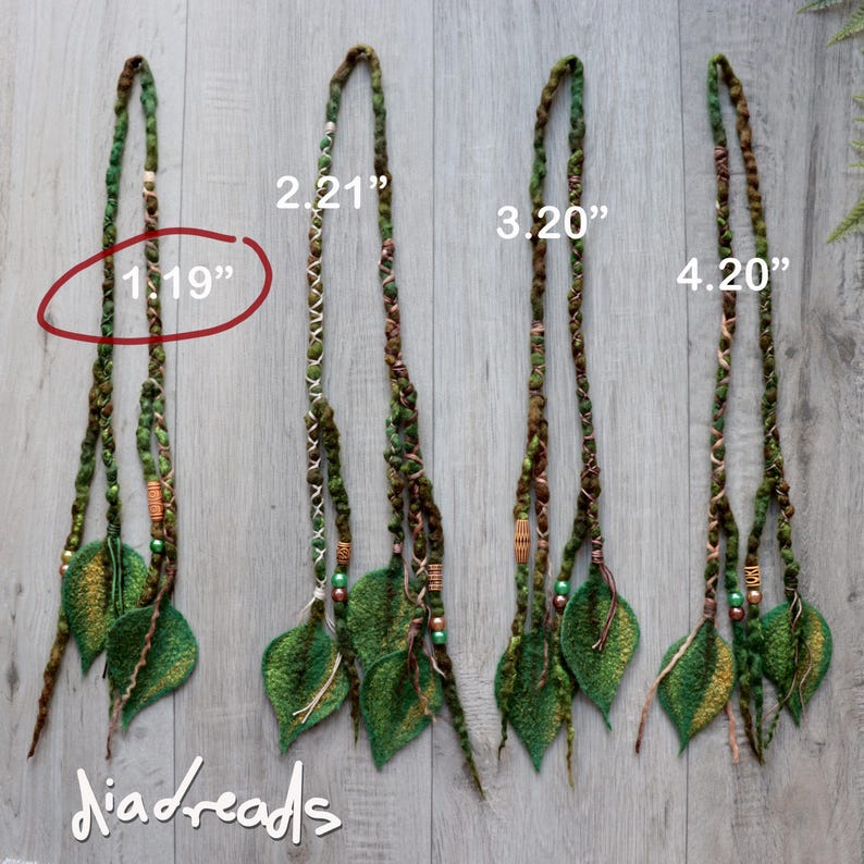 Four hair extensions featuring braided green and brown fibres, accented with small wooden and metallic beads, and finished with felted leaf shapes.