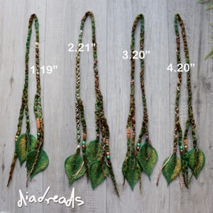 May include: Four sets of hair extensions featuring green and brown braided strands adorned with felted leaf accents and small beads. Each set is labeled with numbers 1.19, 2.21, 3.20, and 4.20 inches, indicating the length of the leaf components.