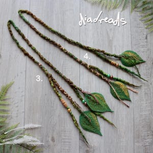 May include: Two long hair extensions labeled 3 and 4, featuring green and brown wrapped fibers, decorative beads, and felted leaf-shaped ends. The text "diadreads" is visible in the upper right corner of the image.