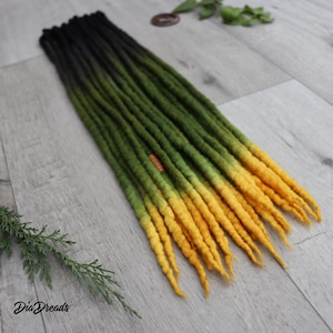 May include: A set of 20 ombre dreadlocks in black, green and yellow colours. The dreadlocks are made of wool and are approximately 61 cm long.