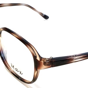 May include: Tortoiseshell eyeglasses with a brown frame and clear lenses. The brand name "Max" is printed on the right lens.