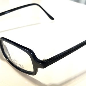 May include: Black rectangular framed eyeglasses with clear lenses.