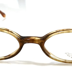 May include: Brown tortoiseshell oval-shaped eyeglasses with clear lenses. The brand name "CELLINI" is visible on the right lens.