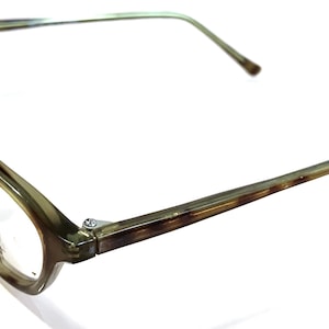 May include: A pair of tortoiseshell eyeglasses with a brown frame and clear lenses.