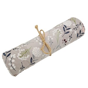 May include: A gray fabric roll with a floral pattern in white, green, and blue. The roll is tied with a natural twine string.