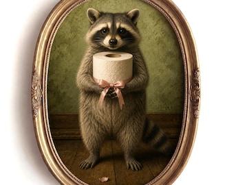 May include: A framed oval wall art piece featuring a gray and black raccoon standing upright. The raccoon is holding a roll of white toilet paper tied with a light pink ribbon. The artwork is encased in an ornate, metallic gold-toned frame.
