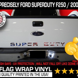 May include: White Ford Super Duty truck with US flag-themed lettering. The text "SUPER DUTY" is displayed across the tailgate. The image includes the text "FITS PRECISELY FORD SUPERDUTY F250 / 2008-13" and "US FLAG WRAP VINYL".