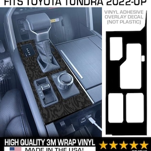 May include: Black and grey patterned vinyl overlay decal for a Toyota Tundra 2022-up. The image shows the decal applied to the centre console of a vehicle. The text on the image reads "Fits Toyota Tundra 2022-up" and "High Quality 3M Wrap Vinyl Made in the USA!"