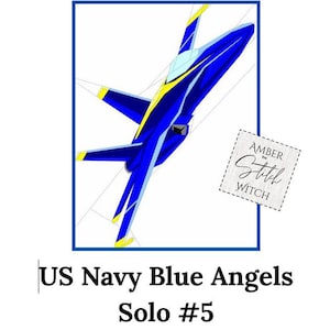 May include: A stylized illustration of a blue and yellow jet plane, set within a blue rectangular frame. The text "US Navy Blue Angels Solo #5" is below the frame. A small square with the text "Amber the Stitch Witch" is in the image.