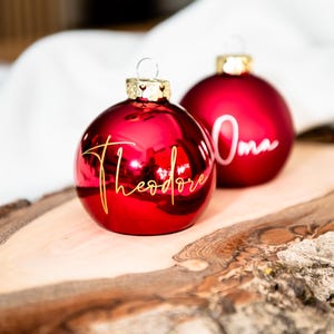 Stylish personalized Christmas bauble in real glass, shiny red