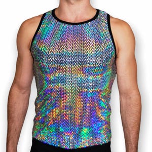 May include: A sleeveless tank top featuring a highly reflective, iridescent holographic finish with a textured, scale-like pattern. The garment is constructed with a solid black trim around the round neckline and the armholes, creating a sharp contrast.