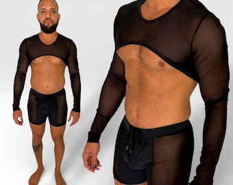 May include: Black mesh long-sleeve crop top and matching shorts. The top has a scoop neck and a large cutout at the chest. The shorts have a drawstring waist and mesh panels. The outfit is designed for a bold look.