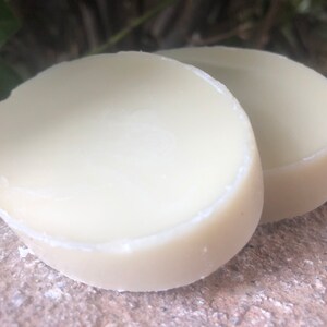 May include: Two round, white, solid, unscented deodorant bars.
