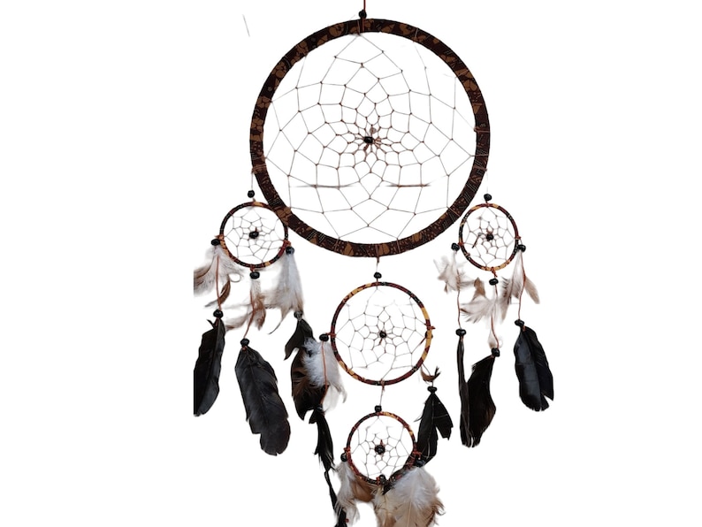 May include: A brown and black dreamcatcher with multiple layers of netting and feathers. The dreamcatcher has a beaded fringe and is decorated with a floral pattern.