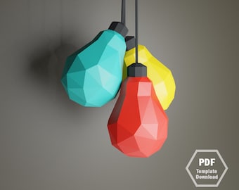 May include: Three geometric pendant lights in teal, red, and yellow hang from black cords. Each light has a faceted design and a black cap. The background is a solid gray.