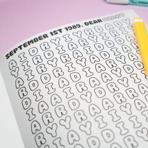 K&ouml;nnte beinhalten: Offene Notizbuchseite mit dem Text "SEPTEMBER 1ST 1989. DEAR DIARY" in schwarzen Buchstaben. Das Wort "DIARY" wird mehrfach wiederholt. Ein gelber Marker befindet sich in der oberen rechten Ecke.