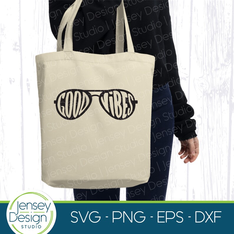 May include: A white tote bag with the text "Good Vibes" in black lettering, styled to look like sunglasses.
