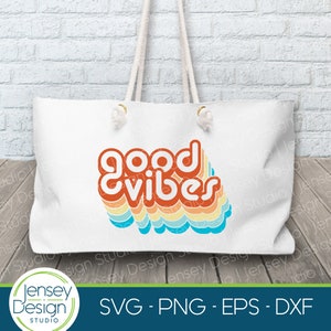 May include: A white tote bag with a colorful retro design that says "good vibes". The design is in shades of orange, yellow, blue, and green.