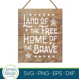 May include: A wooden sign with the text "Land of the Free Home of the Brave" in white lettering. The sign has a distressed wood look and is decorated with stars.