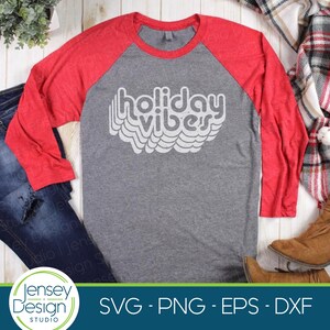 May include: A gray and red baseball tee shirt with the text "holiday vibes" in a white retro font.