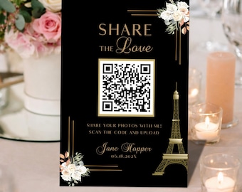 May include: Black wedding invitation card with gold text and a QR code. The card features the text "SHARE THE Love" and "SHARE YOUR PHOTOS WITH ME! SCAN THE CODE AND UPLOAD". The Eiffel Tower is depicted in gold. Floral accents adorn the corners.