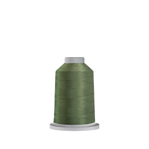May include: A spool of green thread on a white bobbin.