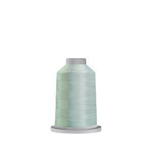 May include: A spool of light blue thread on a white bobbin.
