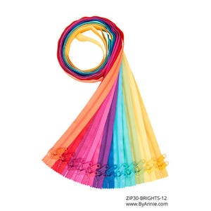 May include: A collection of colorful zippers in a rainbow of hues, including red, orange, yellow, green, blue, and purple. The zippers are arranged in a fan shape, with the zipper pulls visible. The text "ZIP30-BRIGHTS-12" and website address are at the bottom.