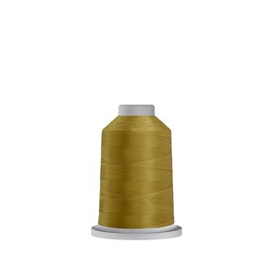 May include: A spool of gold thread for sewing or embroidery.