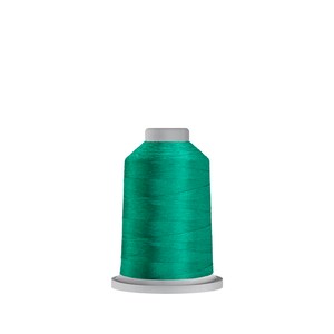 May include: A spool of teal green thread on a white bobbin.