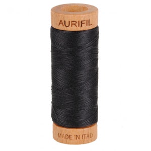 May include: A spool of black thread with a wooden bobbin. The bobbin is labeled "Aurifil" and "Made in Italy".