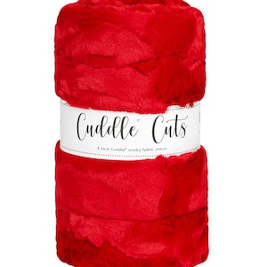 May include: A roll of red Cuddle Cuts minky fabric precut. The fabric is soft and fluffy, and it is perfect for making blankets, pillows, and other crafts.