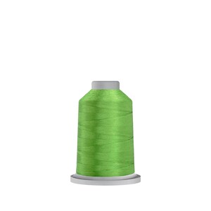 May include: A spool of bright green thread for sewing or embroidery.