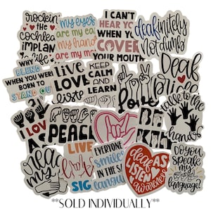 May include: A selection of stickers with phrases and symbols related to deafness and sign language. The stickers feature text such as "Love," "Peace," and "Deaf Pride," alongside hand gestures and heart shapes. The color scheme includes black, white, red, and pink.