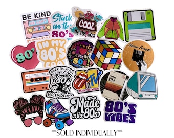 May include: A collection of colorful stickers with 80s themes. Designs include a cassette tape, Rubik's Cube, roller skate, MTV logo, and the phrases "Be Kind," "Cool in the 80s," and "80's Vibes."