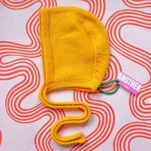 Hand-knitted Adult Bow Tie Bonnet hat in Yellow image 2