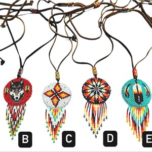 May include: Six beaded necklaces with different designs, including a wolf, feathers, and geometric patterns. Each necklace has a round pendant with a fringe of beads. The necklaces are labelled A through F.
