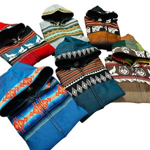May include: Six hooded sweatshirts with different colorful patterns and designs. The sweatshirts have a zipper closure and a hood. The patterns include geometric shapes, animal prints, and tribal designs.