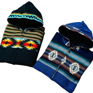 May include: Two hooded jackets with zipper closures. One jacket is black with a colorful geometric pattern and the other is blue with a similar pattern.