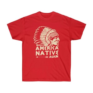 May include: Red t-shirt with a cream-colored graphic of a Native American chief in profile, wearing a headdress. The text "MAKE AMERICA NATIVE AGAIN" is below the image, with an arrow pointing left.