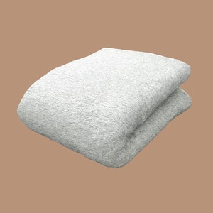 May include: A white fluffy towel folded in half, ready for use.