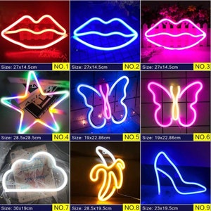May include: Collection of neon light signs in various shapes, including lips, a star, butterflies, a cloud, a banana, and a high-heeled shoe. Each sign has a different color and size, with dimensions in centimeters.
