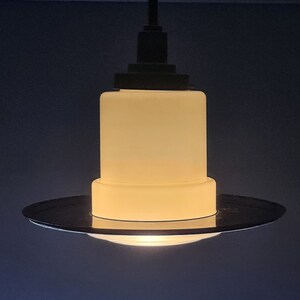 Art Deco chandelier signed in frosted glass and brown bakelite supported by a patinated metal rod
