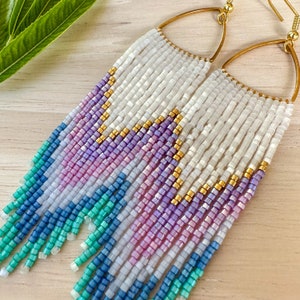 Beaded mermaid blue, aqua, pink, gold, Purple  fringe earrings on rounded triangles.